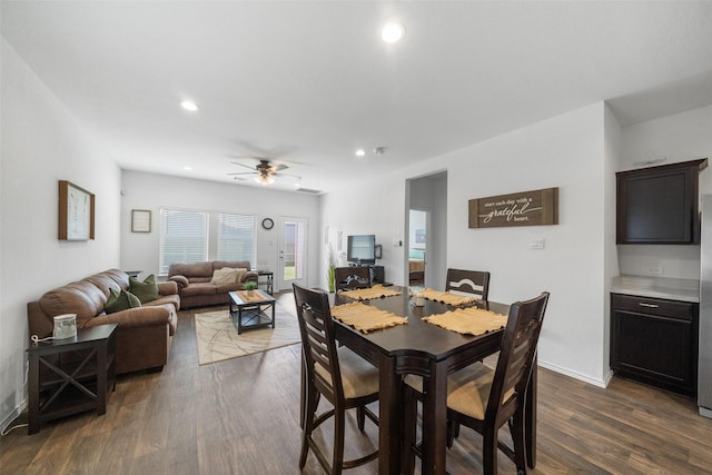 dining space with dark hardwood / wood-style floors and ceiling fan