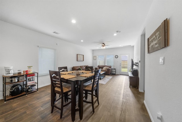 dining space with dark hardwood / wood-style floors and ceiling fan