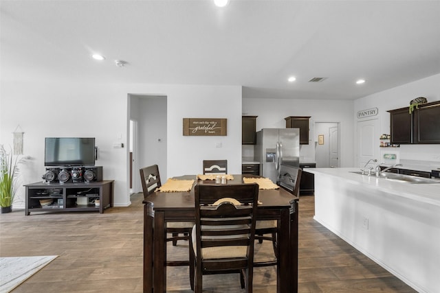 dining area featuring dark hardwood / wood-style flooring and sink