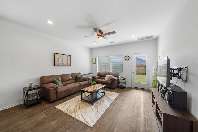 living room featuring dark hardwood / wood-style flooring and ceiling fan