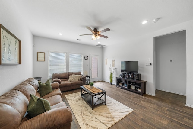 living room featuring ceiling fan and dark hardwood / wood-style flooring