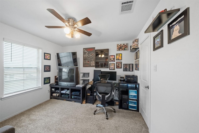 carpeted office with ceiling fan