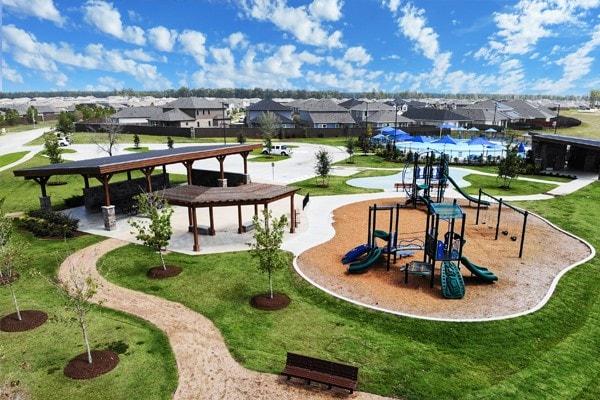 view of home's community featuring a lawn and a playground