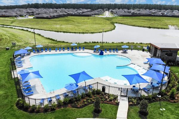 view of pool featuring a lawn and a patio area