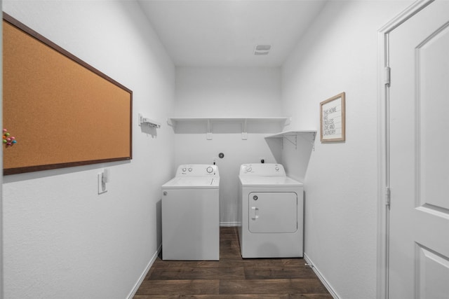 laundry area with washing machine and dryer and dark wood-type flooring