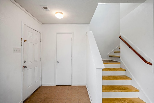 stairs with tile patterned floors