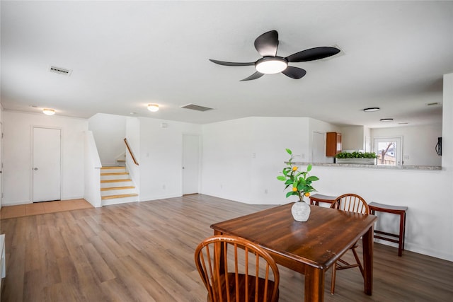 dining space with hardwood / wood-style flooring and ceiling fan