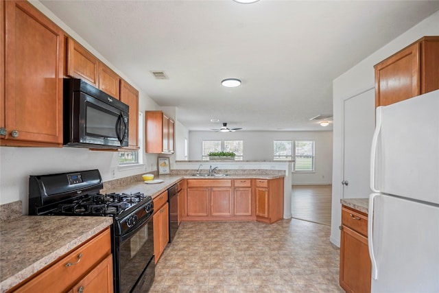 kitchen with ceiling fan, kitchen peninsula, sink, and black appliances