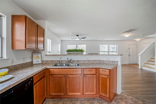 kitchen featuring ceiling fan, black dishwasher, sink, and kitchen peninsula