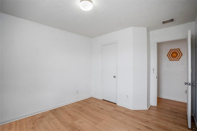 unfurnished bedroom with a closet and light hardwood / wood-style flooring