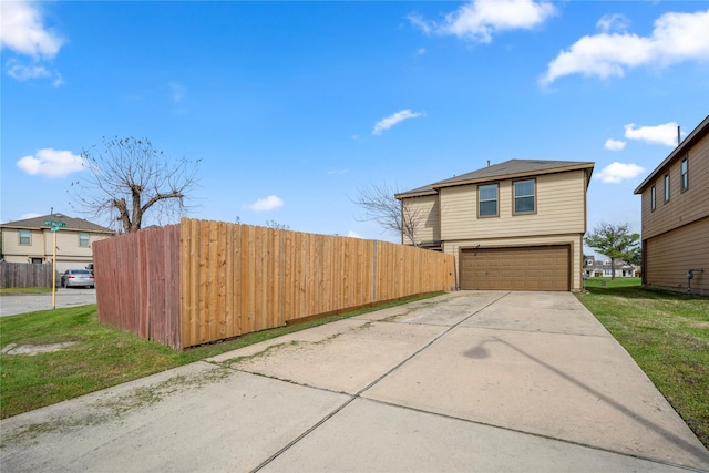 view of side of home with a garage and a yard