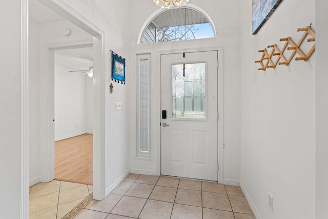 foyer featuring light tile patterned floors and ceiling fan