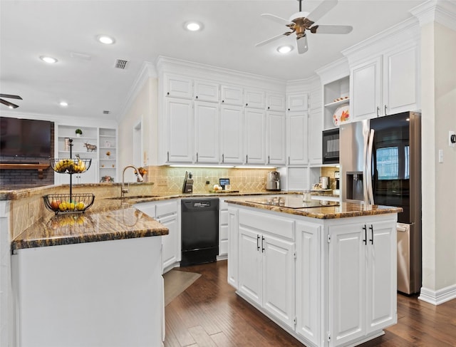 kitchen with a center island, dark stone counters, kitchen peninsula, and black appliances