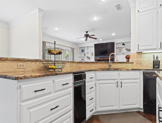 kitchen with sink, dark stone countertops, black dishwasher, white cabinets, and kitchen peninsula