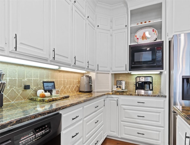 kitchen with decorative backsplash, dark stone countertops, white cabinets, and black appliances