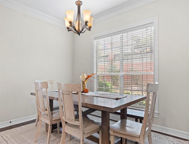 dining room with an inviting chandelier, crown molding, and hardwood / wood-style flooring