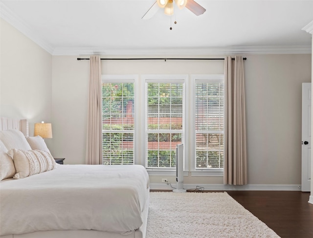 bedroom featuring multiple windows, crown molding, and dark wood-type flooring