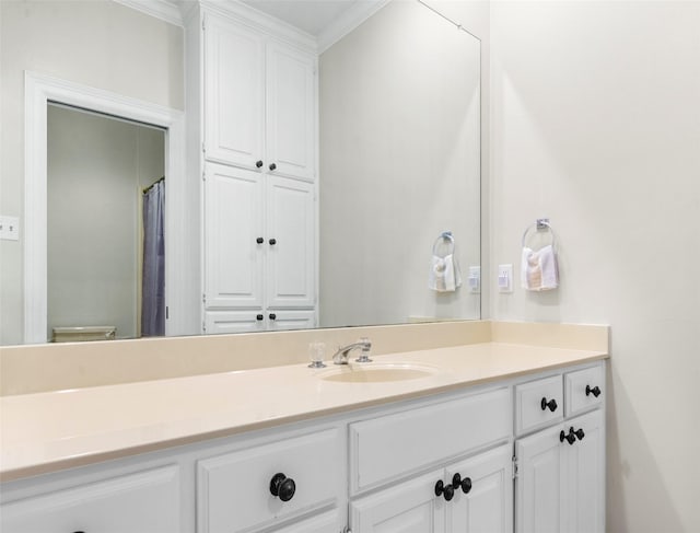 bathroom featuring ornamental molding, vanity, and toilet