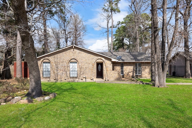 ranch-style house with brick siding, crawl space, a front yard, and fence