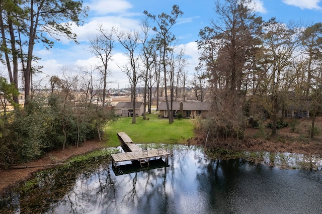 view of dock with a water view and a lawn