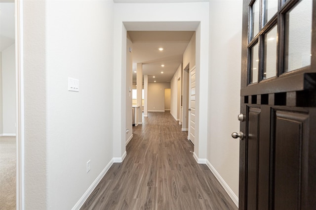 hallway with dark hardwood / wood-style flooring