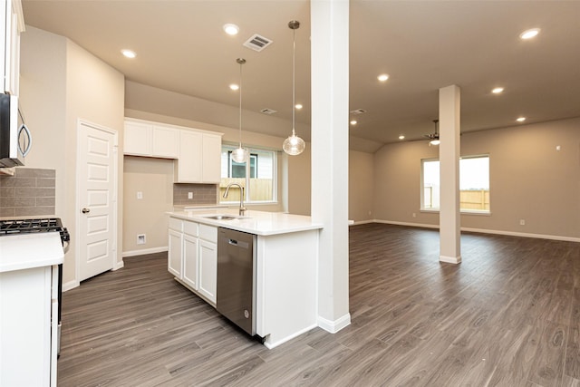 kitchen featuring appliances with stainless steel finishes, sink, hanging light fixtures, and white cabinets