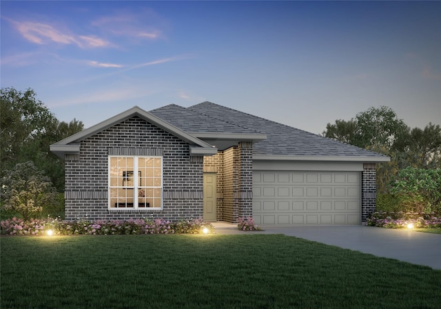 view of front facade with a yard and a garage