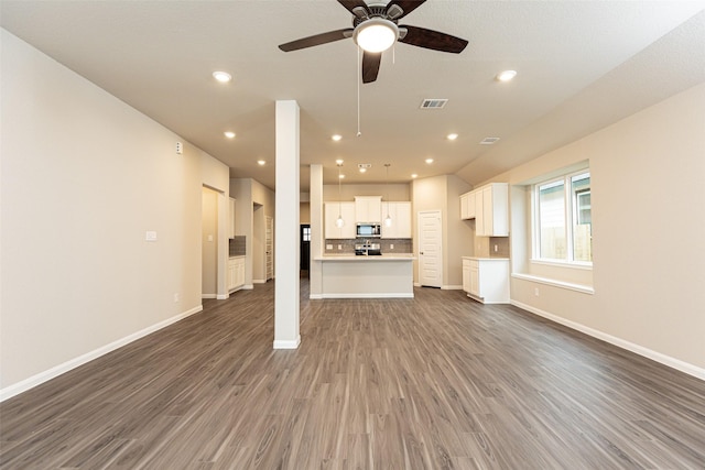 unfurnished living room with ceiling fan and dark hardwood / wood-style flooring