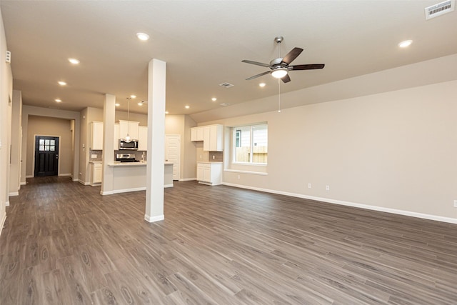 unfurnished living room featuring dark hardwood / wood-style floors and ceiling fan