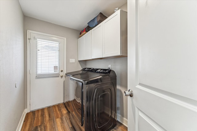 washroom with cabinets, dark hardwood / wood-style flooring, and washer and clothes dryer