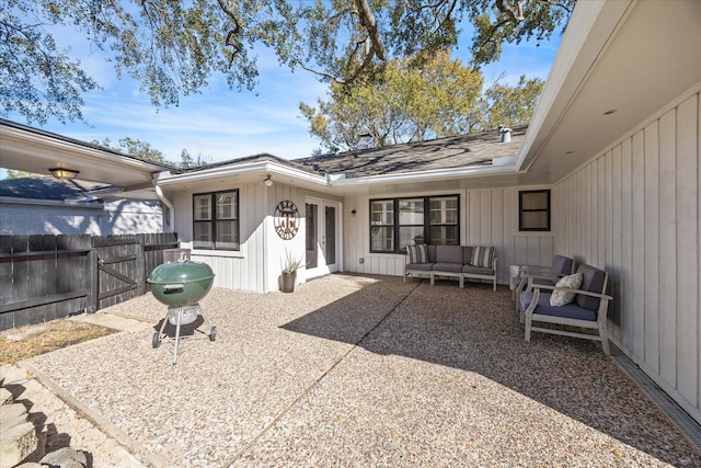 rear view of house featuring an outdoor living space and a patio