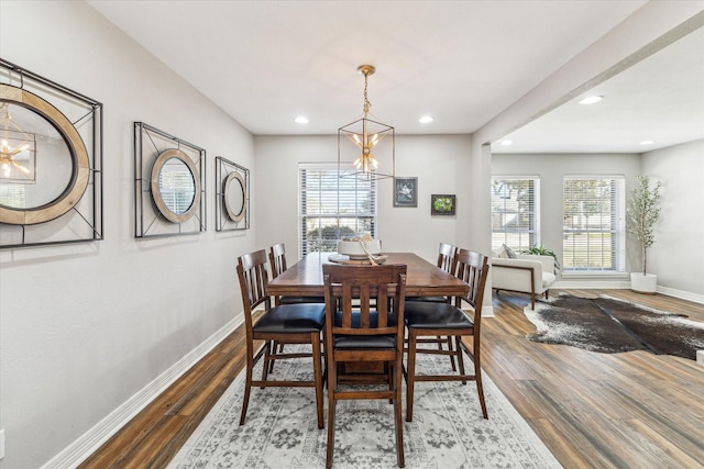 dining room featuring hardwood / wood-style flooring and a notable chandelier