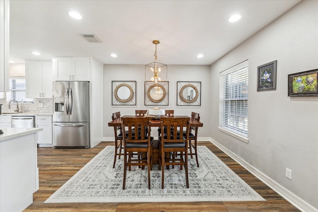 dining area with dark wood-type flooring and sink