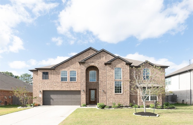 view of front of home with a garage and a front lawn