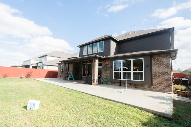 back of property featuring a yard and a patio