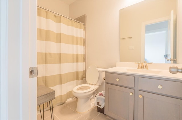 bathroom featuring vanity, toilet, and tile patterned flooring