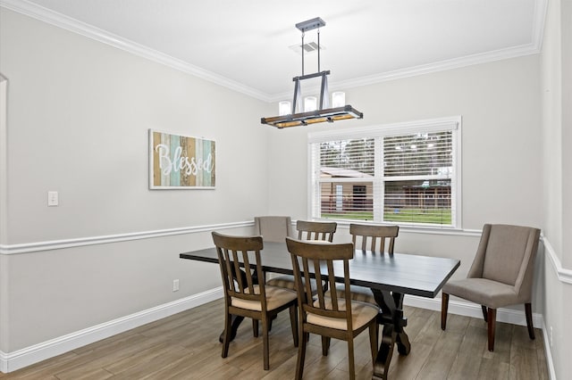 dining space with crown molding and hardwood / wood-style flooring