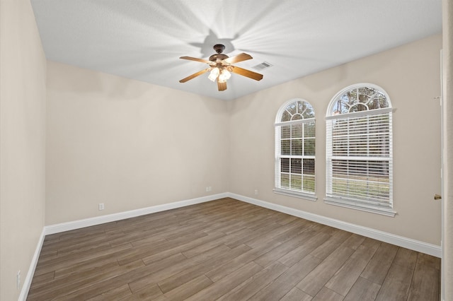 unfurnished room with ceiling fan and hardwood / wood-style floors