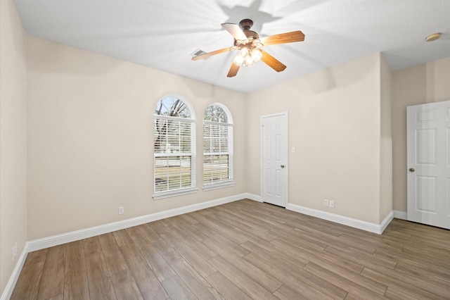 unfurnished room featuring light hardwood / wood-style floors and ceiling fan