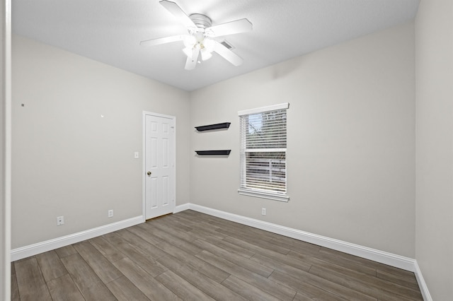 unfurnished room with hardwood / wood-style floors and ceiling fan