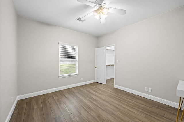 unfurnished room with hardwood / wood-style floors and ceiling fan