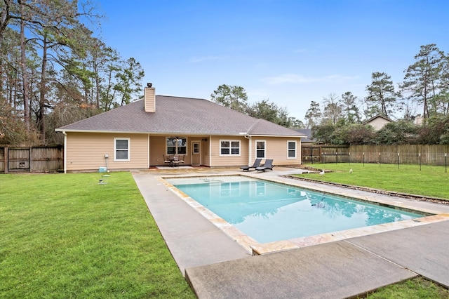 view of swimming pool featuring a yard and a patio area