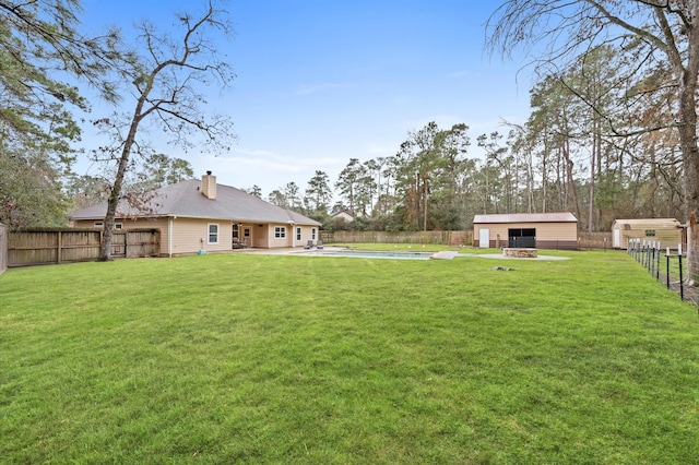 view of yard with an outbuilding and a fenced in pool