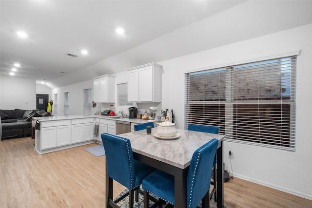 dining area featuring sink and light hardwood / wood-style flooring