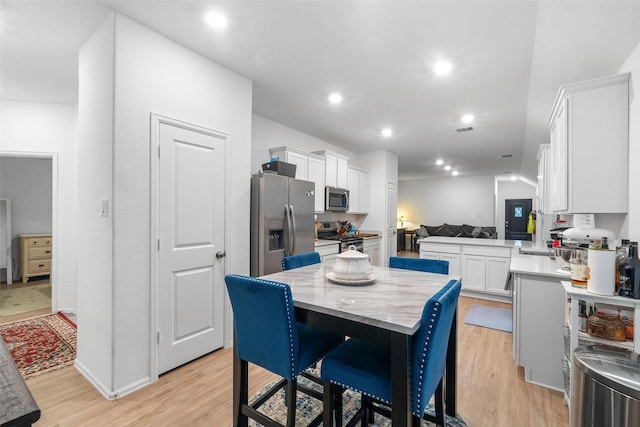 dining area with light hardwood / wood-style flooring