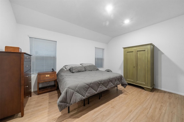 bedroom featuring vaulted ceiling and light hardwood / wood-style flooring