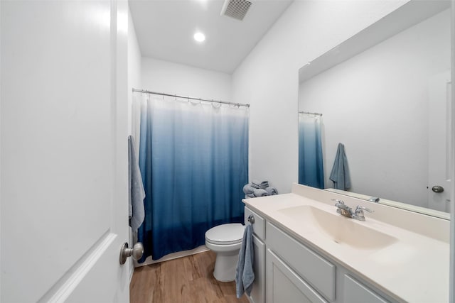 bathroom with vanity, wood-type flooring, and toilet