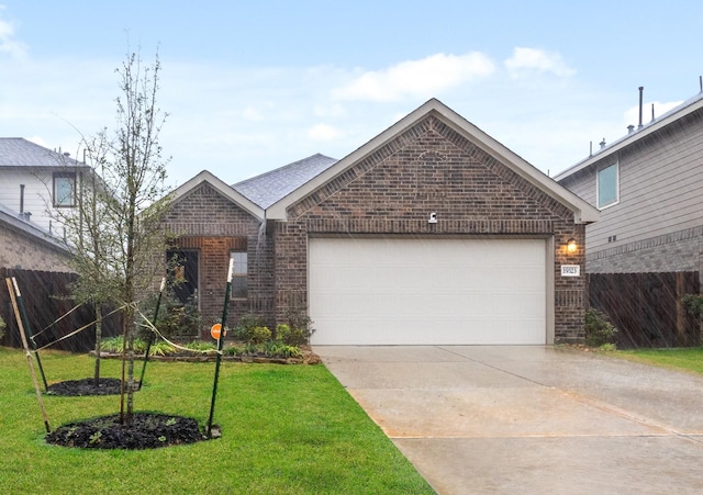 view of front of property with a garage and a front yard