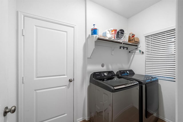 clothes washing area featuring washer and dryer