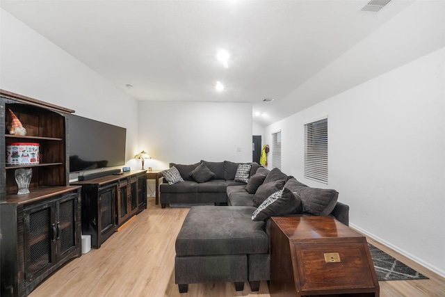 living room with lofted ceiling and light hardwood / wood-style flooring